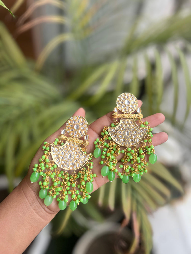 Shop Traditional Elegance with Jaipuri Kundan Jhumki Style Dangler Earrings in light green. Crafted with intricate detailing, these stunning earrings add a royal touch to any outfit. Perfect for festive occasions and weddings.