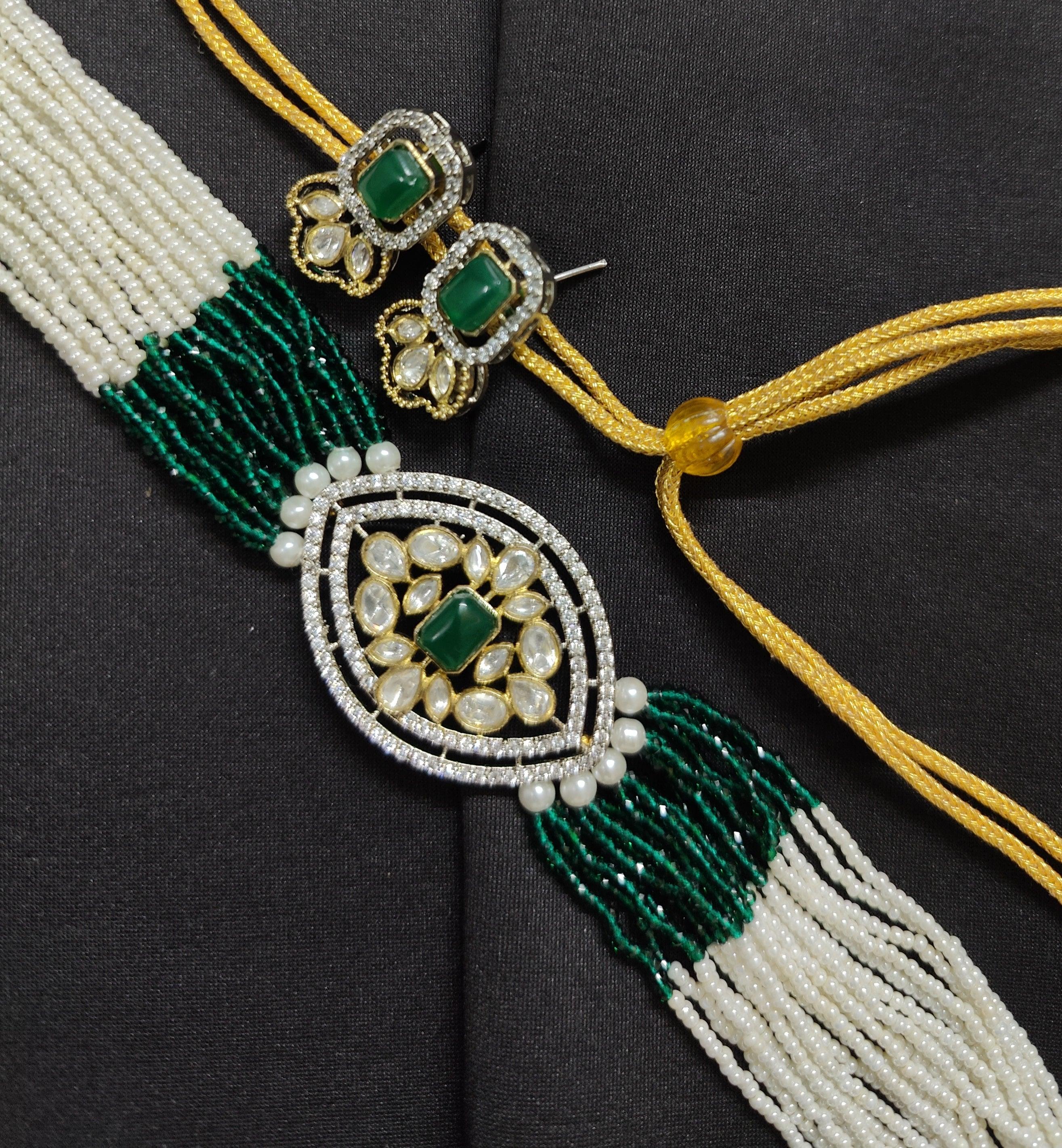 Bonhams. London. UK 18 Oct 2018 - A woman holds an emerald and diamond set  necklace from India (Late 19th Century) (est - £15,000- £20,000) A preview  of Bonhams Islamic and Indian,